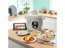 Charger l&#39;image dans la galerie, Scène de cuisine avec un Moulinex Cookeo gris, de la nourriture, une tablette.
