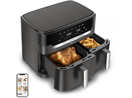 Friteuse à air Dual Easy Fry avec deux compartiments. Un poulet cuit, l'autre frites.