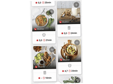 Charger l&#39;image dans la galerie, Une main tient un smartphone affichant une application de recettes avec diverses images de plats et des options de recherche sur une table en bois.
