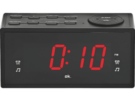 Réveil numérique noir affichant 0:10 en rouge, avec des boutons et des notes de musique.