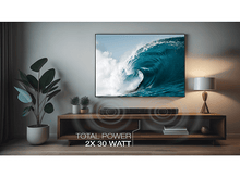 Charger l&#39;image dans la galerie, Scène de salon avec TV affichant une vague. Barre de son sur meuble en bois.
