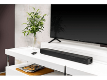 Charger l&#39;image dans la galerie, Une barre de son noire, une télévision et une décoration sur une étagère blanche.
