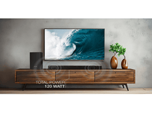 Charger l&#39;image dans la galerie, Une configuration de divertissement à domicile avec une TV, une barre de son et un caisson de basses sur un meuble en bois.
