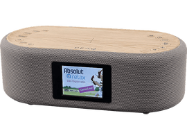 Haut-parleur moderne avec dessus en bois et côtés en tissu. Un écran affiche du contenu radio numérique.