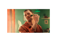 Charger l&#39;image dans la galerie, Homme se rasant avec une tondeuse bleue et noire, avec un fond de mur vert.
