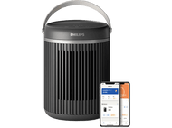 Purificateur d'air Philips noir avec poignée et deux téléphones montrant des écrans d'application, sur fond noir.