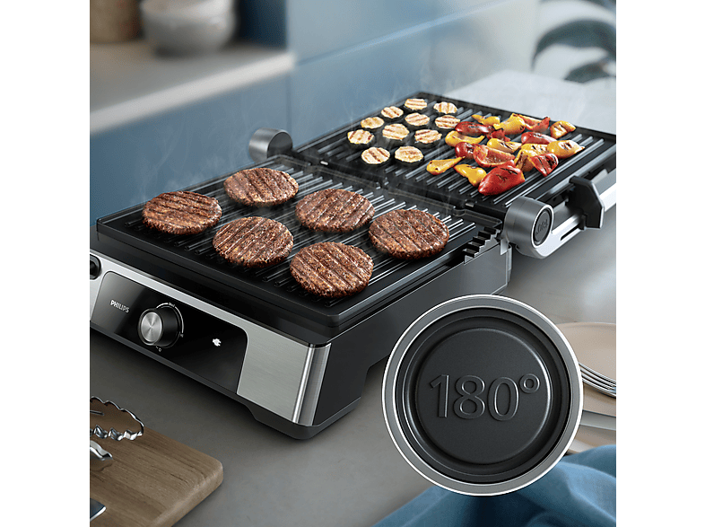 Gril électrique avec hamburgers et légumes grillés, design noir et argent.