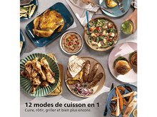 Charger l&#39;image dans la galerie, Une table avec divers plats : poulet rôti, soupe, kebabs, burgers, légumes et sauces. Mains se servant.
