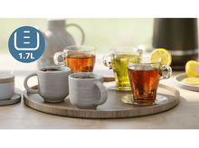 Charger l&#39;image dans la galerie, Quatre tasses et verres avec du thé et du citron sur un plateau en bois, avec une bouilloire.
