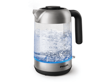 Charger l&#39;image dans la galerie, Une bouilloire électrique argentée et en verre avec de l&#39;eau bouillante et une base lumineuse bleue.
