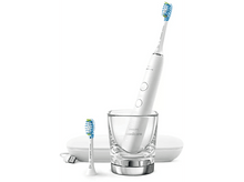 Charger l&#39;image dans la galerie, Brosse à dents Philips Sonicare blanche avec chargeur et tête de brosse supplémentaire dans un verre.
