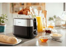 Charger l&#39;image dans la galerie, Un grille-pain avec un croissant dessus, à côté d&#39;articles de petit-déjeuner.
