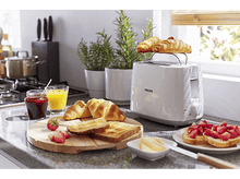 Charger l&#39;image dans la galerie, Scène de petit-déjeuner. Grille-pain avec croissants dessus, jus, confiture, fraises, toasts et beurre.
