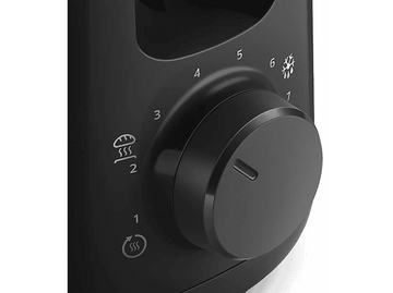 Gros plan sur le cadran de commande d'un grille-pain noir avec des réglages numérotés.