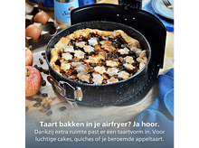 Charger l'image dans la galerie, Tarte aux pommes dans un moule, entourée de pommes et d'œufs sur du bois. La tarte a des décorations en forme d'étoile.
