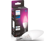 Charger l&#39;image dans la galerie, Une ampoule intelligente Philips Hue dans une boîte et une autre ampoule à côté, toutes deux avec une lueur blanche et rose.
