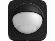 Détecteur de mouvement noir avec un devant blanc arrondi et un dessus noir incurvé.