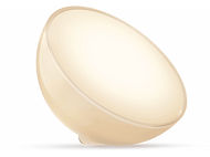 Une lumière blanche et beige en forme d'œuf. Elle est éclairée et sur fond noir.