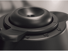 Charger l'image dans la galerie, Gros plan d'un objet en plastique noir. Il possède une caractéristique centrale concave, un cadran et un levier. Des chiffres sont en relief sur la surface.
