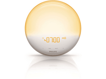Charger l&#39;image dans la galerie, Une lampe de réveil Philips blanche et dorée affichant l&#39;heure 07:00, avec des icônes.
