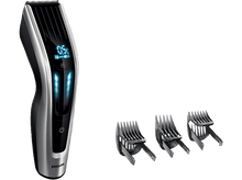 Charger l'image dans la galerie, Une tondeuse à cheveux Philips avec un affichage numérique et trois sabots. La tondeuse est argentée et noire.
