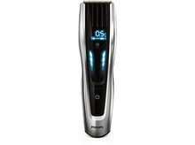 Charger l'image dans la galerie, Tondeuse à cheveux Philips argent et noir, lumières bleues sur l'écran. Fond blanc.
