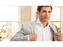 Charger l&#39;image dans la galerie, Un homme en chemise blanche et veste gris clair, ajustant sa veste.
