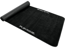 Charger l&#39;image dans la galerie, Un tapis Playseat noir enroulé sur un fond noir.
