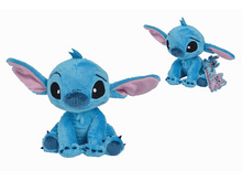 Charger l&#39;image dans la galerie, Peluche Stitch bleu avec de grandes oreilles et un petit jouet.
