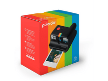 Charger l&#39;image dans la galerie, Un appareil photo Polaroid noir avec une bande arc-en-ciel est à côté d&#39;une boîte colorée. La boîte a du texte et des images.
