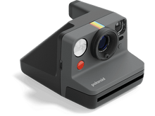 Charger l&#39;image dans la galerie, Appareil photo Polaroid, corps gris, objectif noir, bouton rouge, bande arc-en-ciel et flash. Isolé sur noir.
