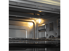 Charger l&#39;image dans la galerie, L&#39;intérieur d&#39;un four avec une lumière allumée. Des grilles sont visibles. Les parois sont métalliques.
