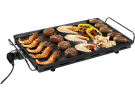 Gril avec crevettes, poisson, saucisses et légumes. Surface noire avec poignée.