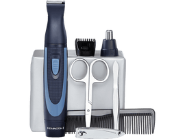 Un kit de toilettage avec tondeuse, ciseaux, peigne et autres outils sur une surface claire.