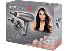 Charger l&#39;image dans la galerie, Boîte du sèche-cheveux Remington Keratin Protect. Une femme est présentée. Le sèche-cheveux est gris et rose.
