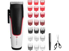 Tondeuse à cheveux avec accessoires, peigne et ciseaux. Tondeuse noire et blanche avec des accents rouges et accessoires.