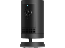 Charger l&#39;image dans la galerie, Une caméra de sécurité Ring noire est posée sur une base noire sur fond noir.
