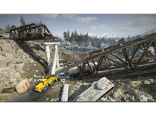 Charger l&#39;image dans la galerie, Pont ferroviaire effondré avec pelle jaune, wagons et montagnes en arrière-plan.
