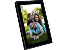 Charger l&#39;image dans la galerie, Un aspirateur robot blanc nettoie sous un meuble en bois.
