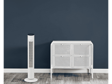 Charger l&#39;image dans la galerie, Un ventilateur tour blanc et un meuble blanc contre un mur bleu foncé sur un sol en bois. Les deux sont des designs modernes.
