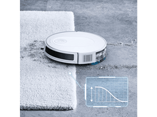 Charger l&#39;image dans la galerie, Un aspirateur robot blanc nettoyant un sol gris à côté d&#39;un tapis blanc.
