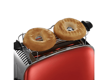 Charger l&#39;image dans la galerie, Grille-pain rouge avec deux bagels grillés sur la grille chauffante, lumière chaude.
