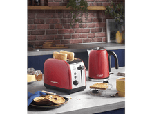 Charger l&#39;image dans la galerie, Grille-pain rouge avec toasts et une bouilloire rouge sur un comptoir, fond de mur en briques.
