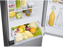 Charger l'image dans la galerie, Réfrigérateur ouvert montrant des fruits et légumes dans les tiroirs, avec des œufs et des bocaux sur les étagères.
