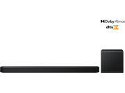 Barre de son et caisson de basses noirs sur fond noir. Logo DTS:X dans le coin.