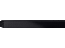 Charger l&#39;image dans la galerie, Un ensemble barre de son et caisson de basses noir contre un mur et un sol gris.
