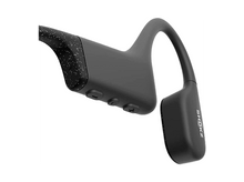 Charger l&#39;image dans la galerie, Casque Shokz noir, avec un motif moucheté à une extrémité. Le mot SHOKZ est visible sur l&#39;écouteur. Boutons sur le côté.
