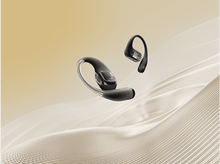 Charger l&#39;image dans la galerie, Deux écouteurs Shokz noirs sur une surface ondulée.
