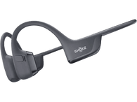 Casque à conduction osseuse gris foncé sur fond noir, avec un design incurvé et une marque.