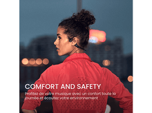 Charger l&#39;image dans la galerie, Une femme avec des écouteurs, veste rouge, regardant vers la gauche. Fond de nuit.
